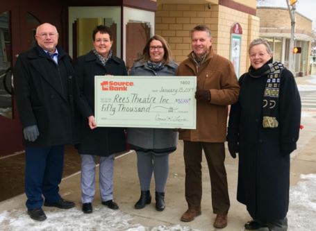 Giant prop check being presented to members of the Rees Theatre project.
