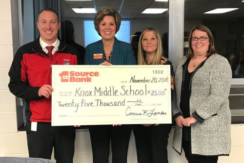 Giant prop check being presented to Knox Middle School administration.