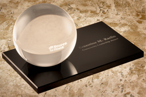 Ernestine M. Raclin Award -- a clear, solid glass globe on a solid black base