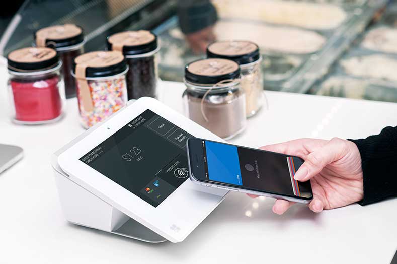 Customer paying with phone using Clover technology.
