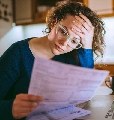 Woman reviewing her finances and stressing out.