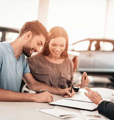 Couple signing for a car