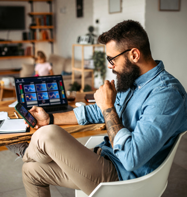 Cryptocurrency investor trading at home using his laptop