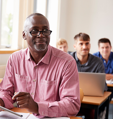 Older gentleman using tablet during a class.
