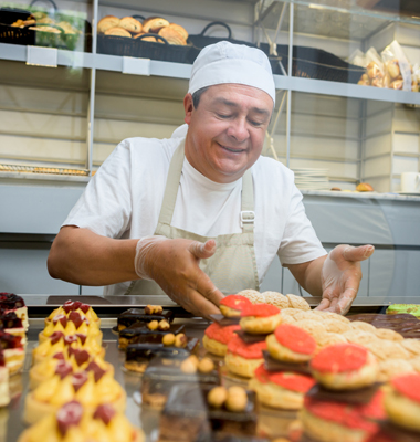 Baker displaying his cookie creations