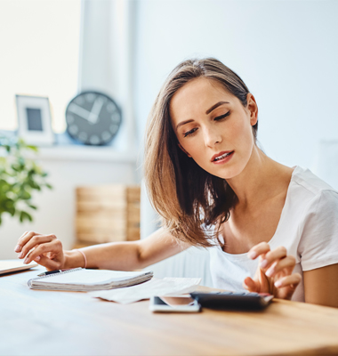 Woman calculating numbers off pay stub