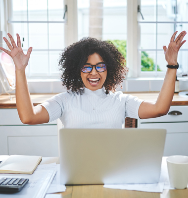 Woman celebrating at her computer