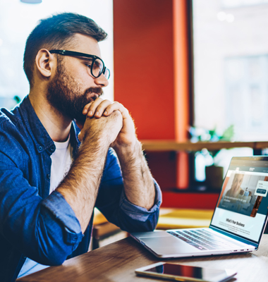 Small business owner working at his laptop.