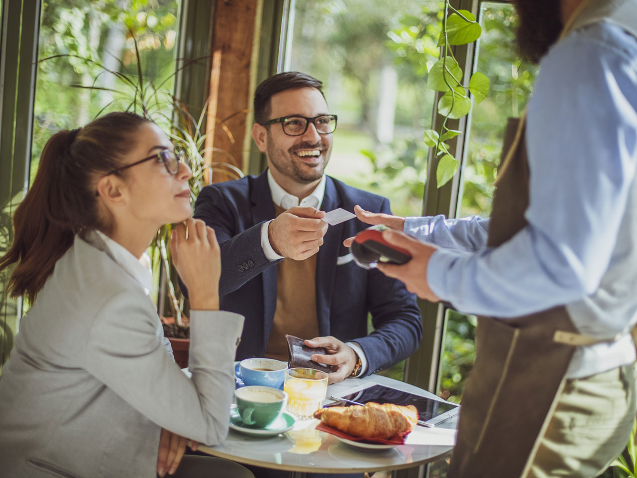 Restaurant customer paying with credit card.