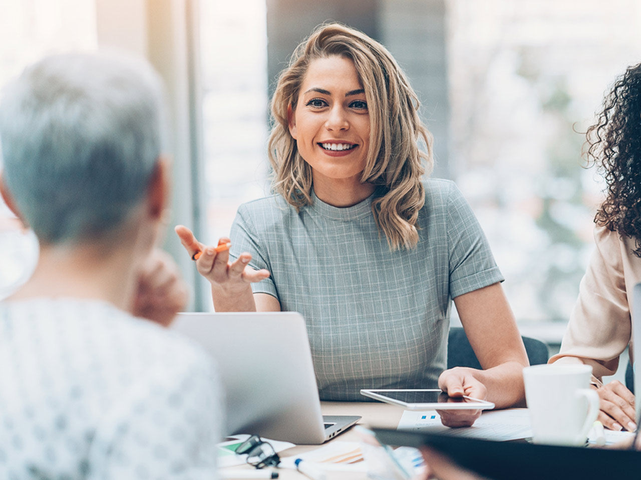 Female business owner meeting with staff.