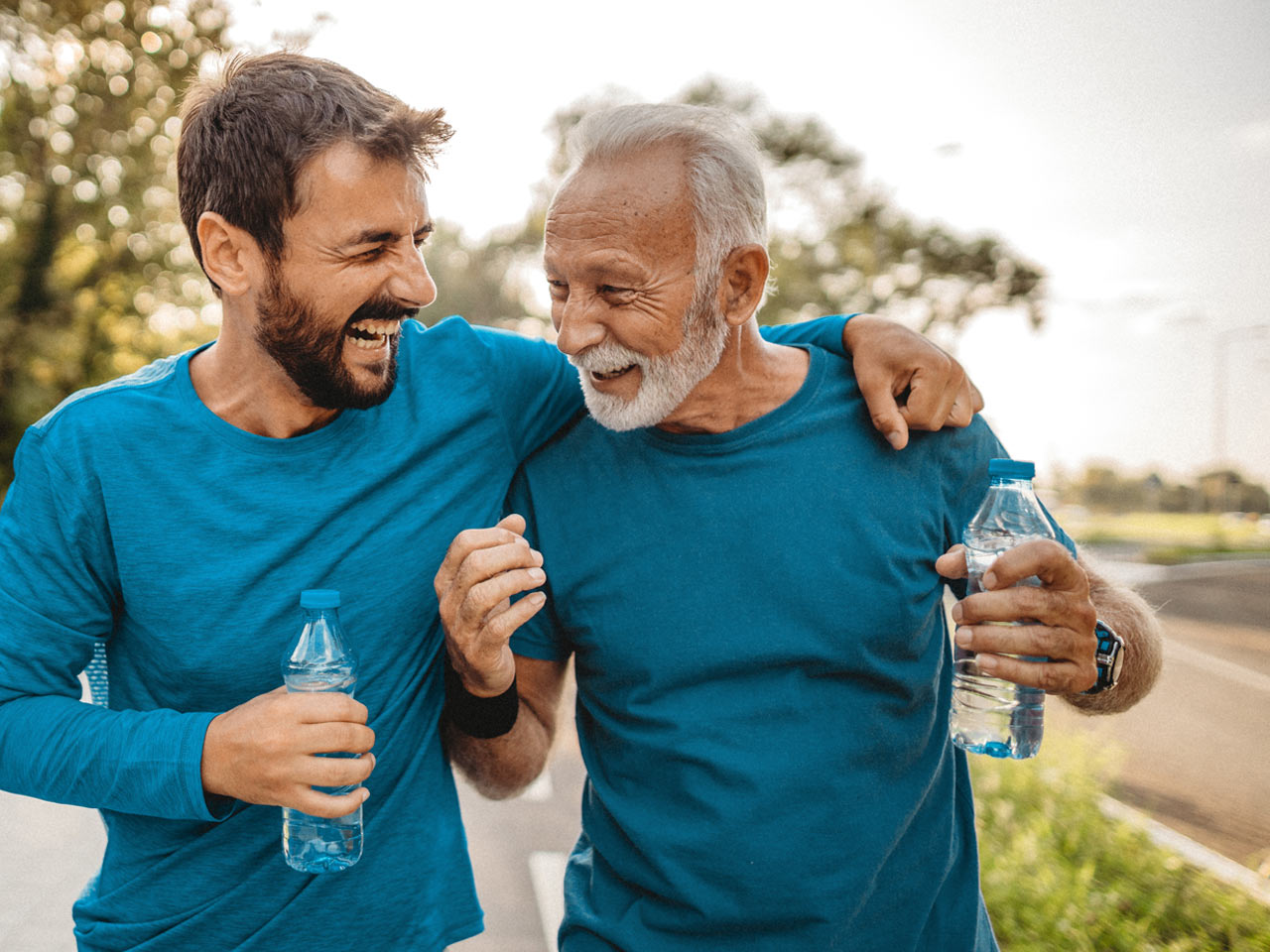 Grown son running with retired father.