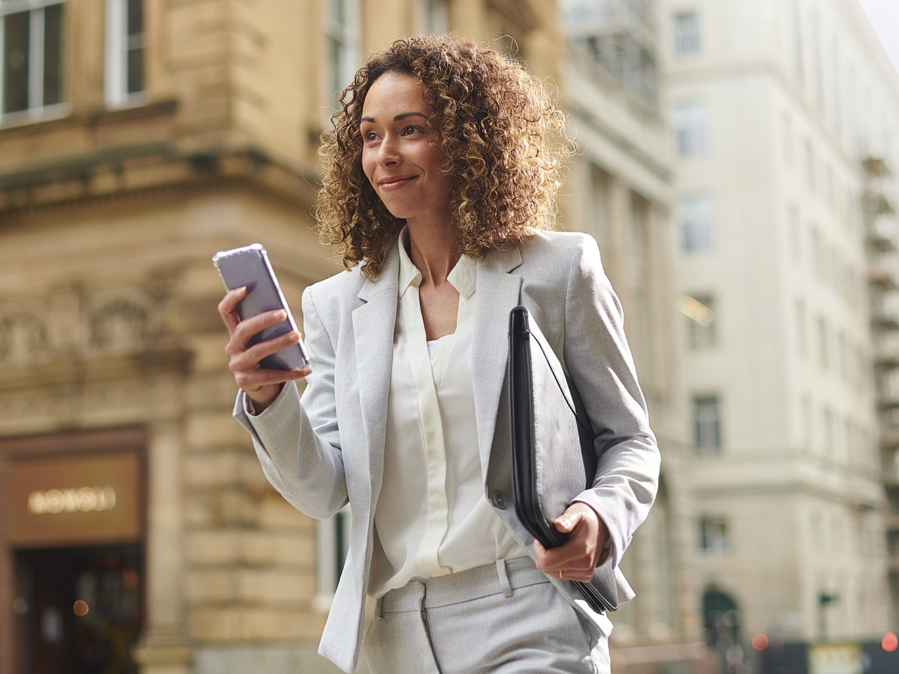 Confident young businesswoman walking down street to her next meeting.