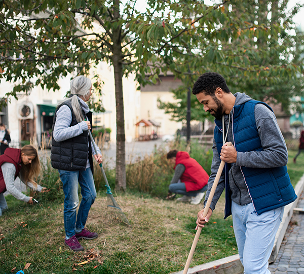 Company volunteers raking
