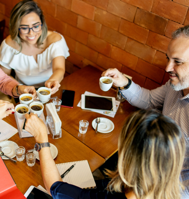 Group of business people meeting in coffee shop.