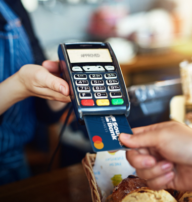 1st Source Bank Business Debit card being inserted into card reader.