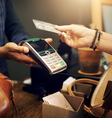 Contactless credit card transaction at high-end store.