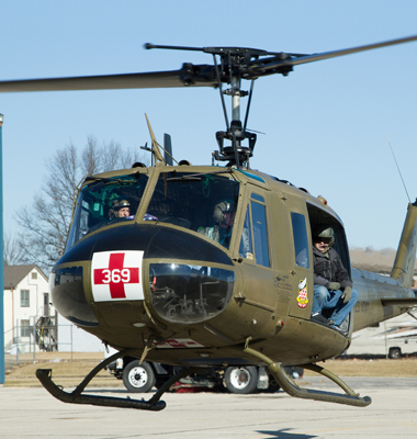 Huey Army medical helicopter taking off.
