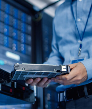 Hard drive being inserted into large server array.