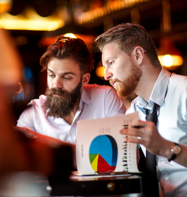 Two young male business owners going over financial data.