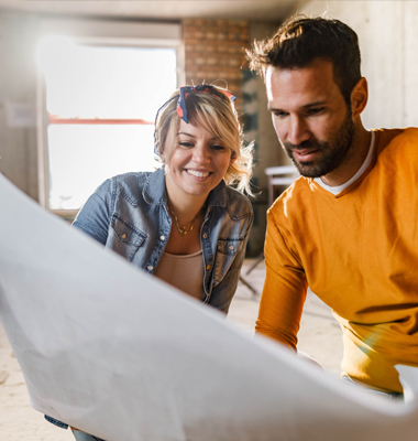 Couple going over plans for a household renovation.
