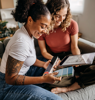 Female roommates choosing a paint color for their living room.