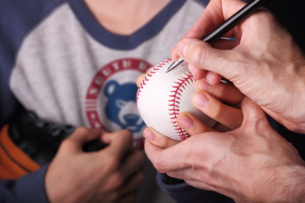 South Bend Cubs player signing a baseball