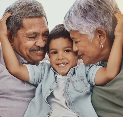 Older couple playing with their grandson