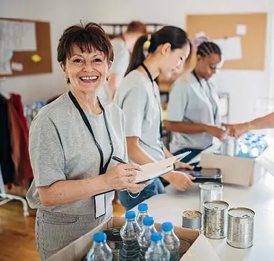 A diverse team of workers in a warehouse, sorting and organizing products for shipment.