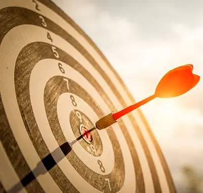A dart hitting the bullseye on a dartboard, demonstrating precision and accuracy