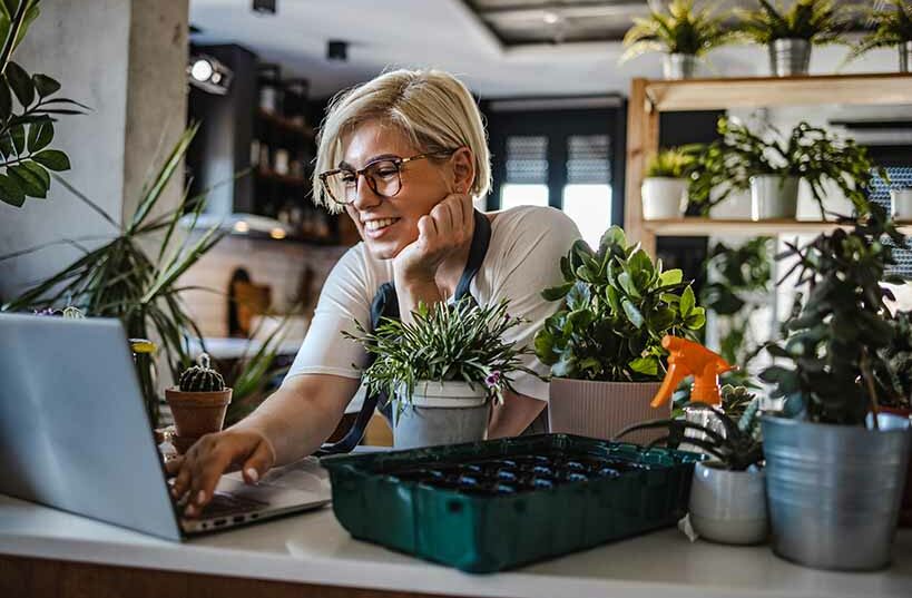 A cheerful flower shop owner arranging a vibrant bouquet of fresh flowers.