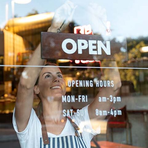 Woman opening a restaurant at the start of a business day