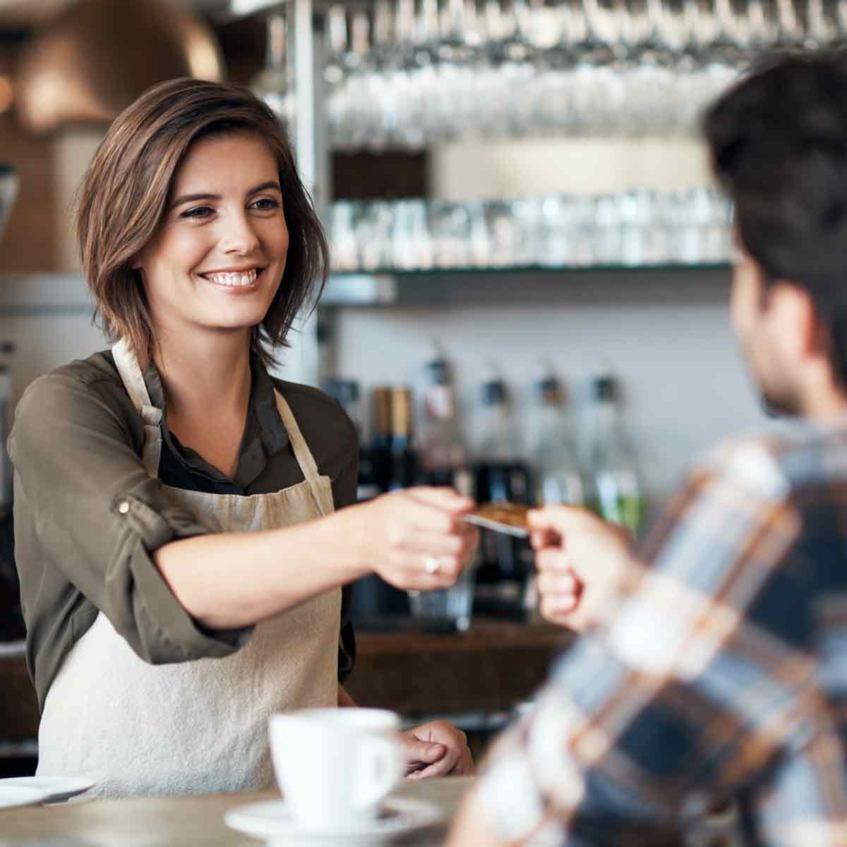 Customer paying with credit card at a café counter