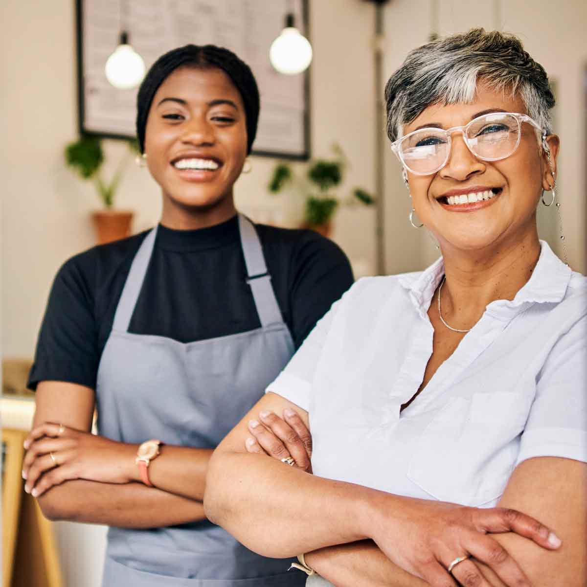 . Two women happily posing outside a coffee shop