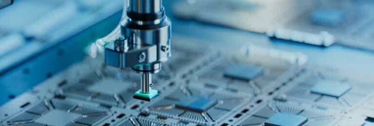 A close-up of a fabricating machine creating a microchip