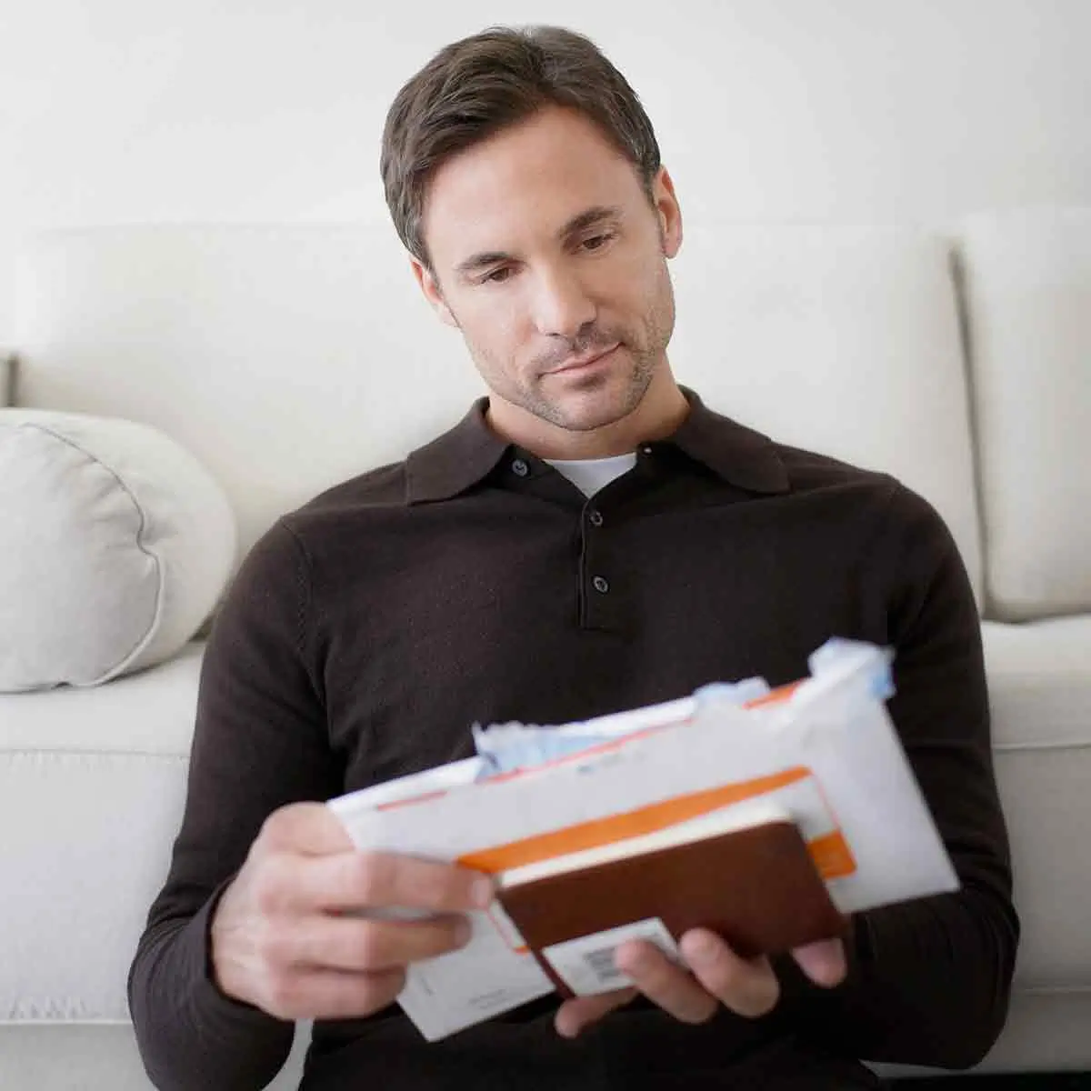 Person organizing bills and financial statements for effective financial planning