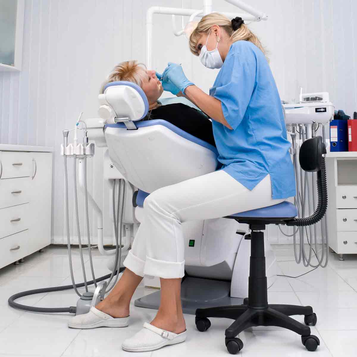 Dentist performing an oral examination on a patient.