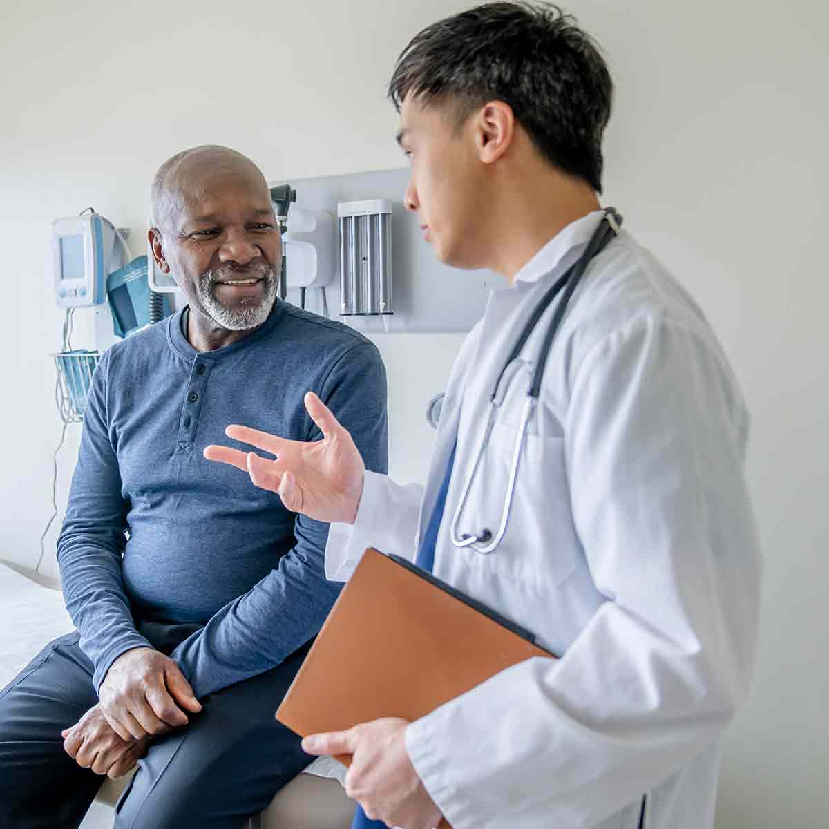 Doctor speaking with a patient in the office, discussing healthcare options.