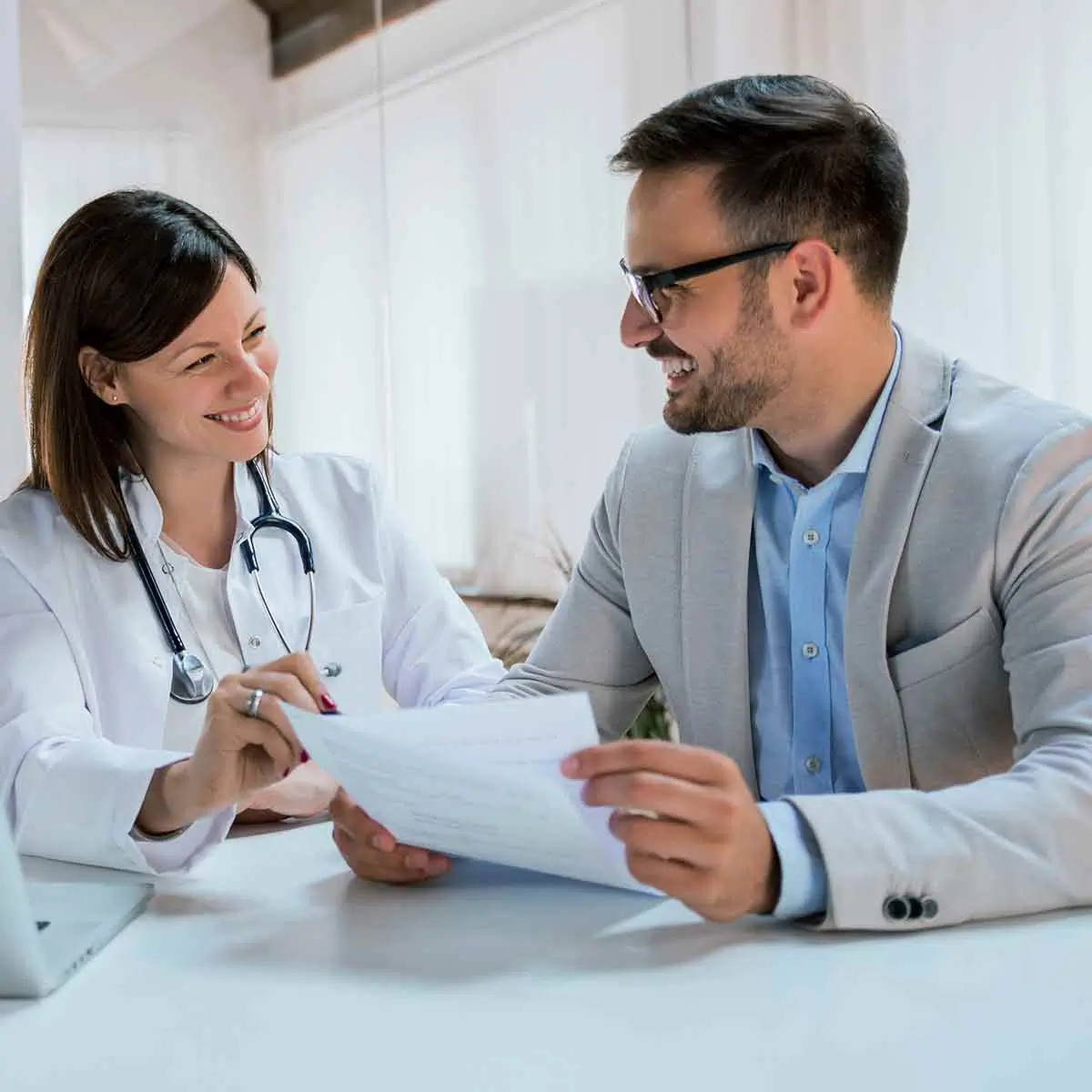 Doctor reviewing medical practice loan options with their private banker