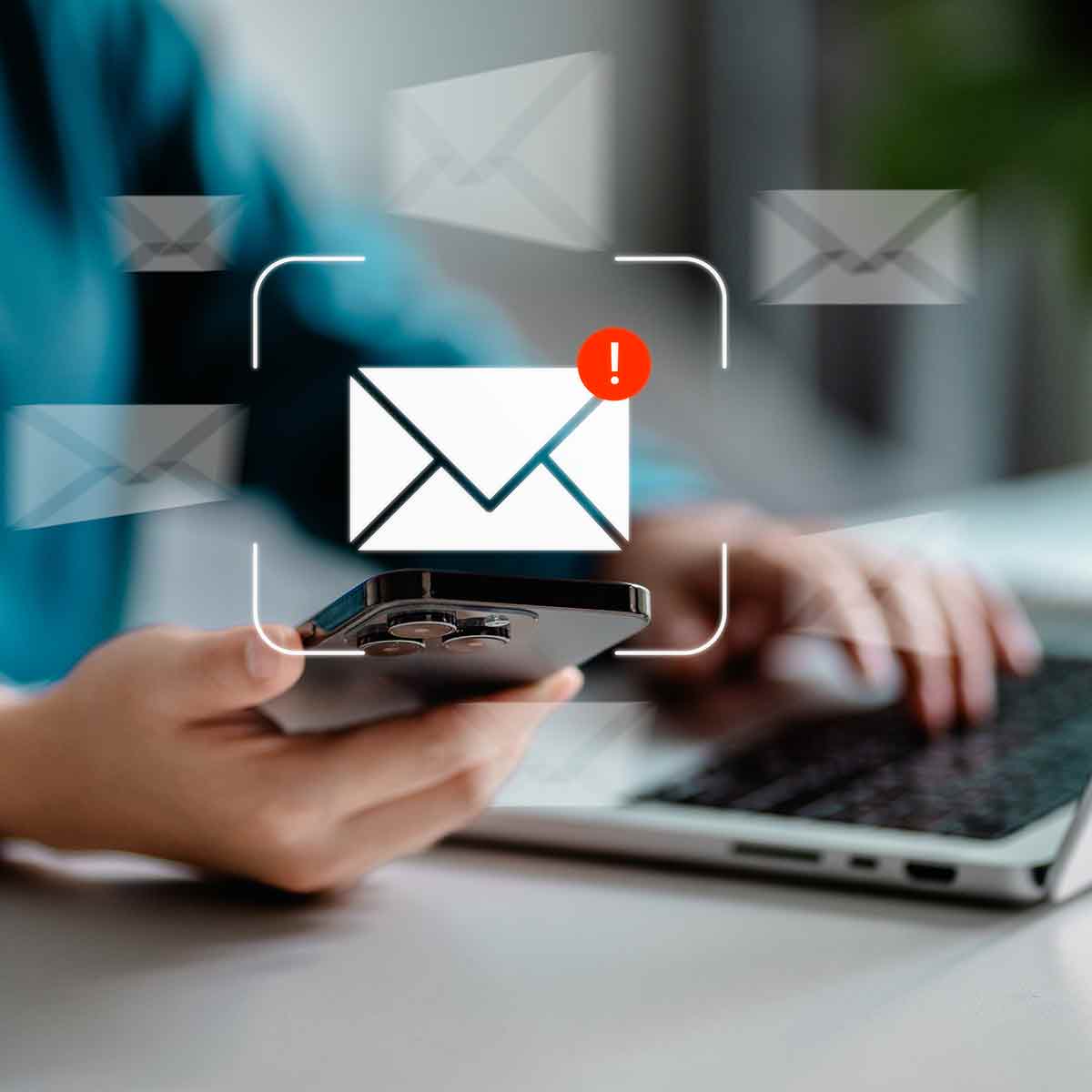 Email alert warning of a possible phishing attempt displayed on a computer screen and cell phone.