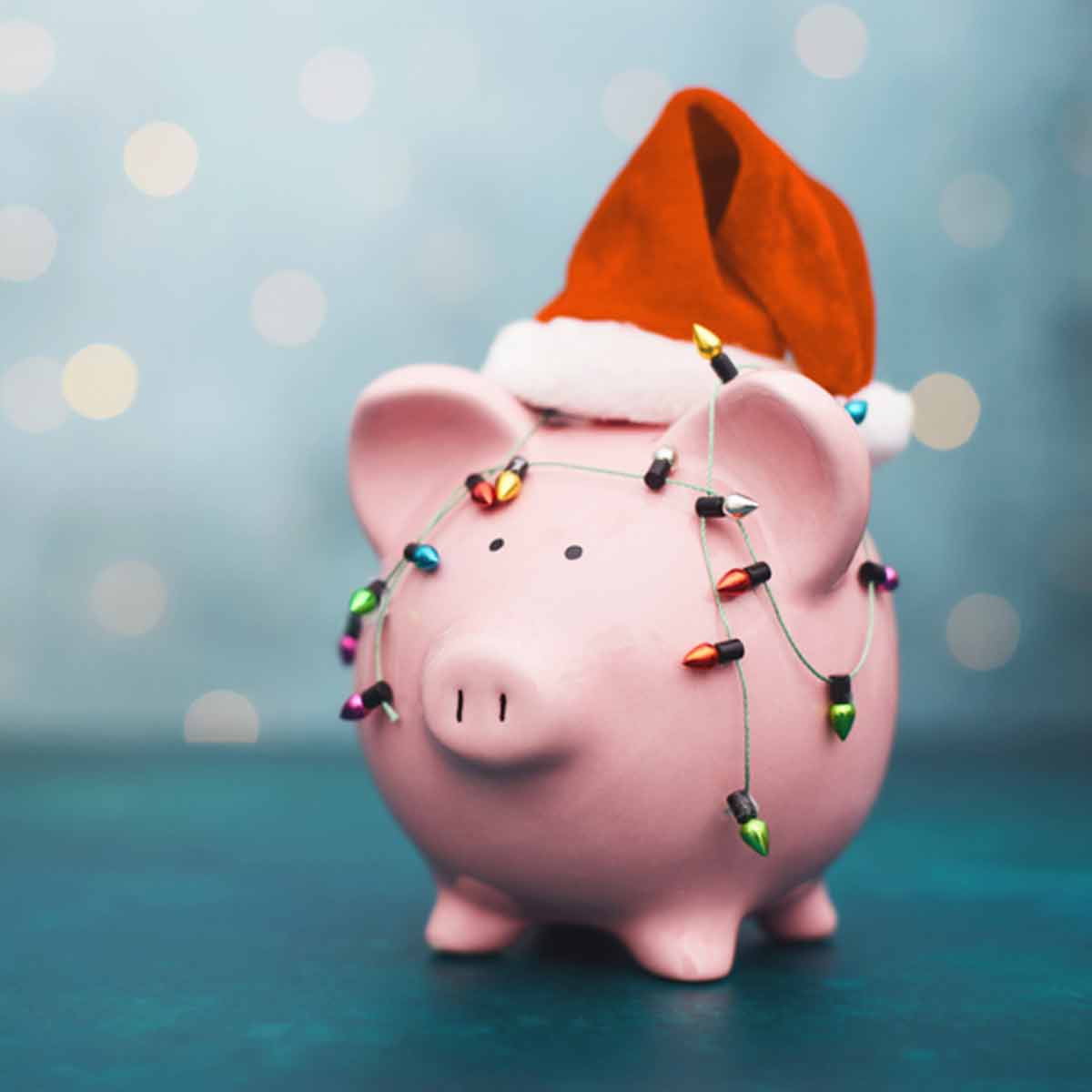 Piggy bank wearing a Santa hat, symbolizing planning ahead and saving for the holidays