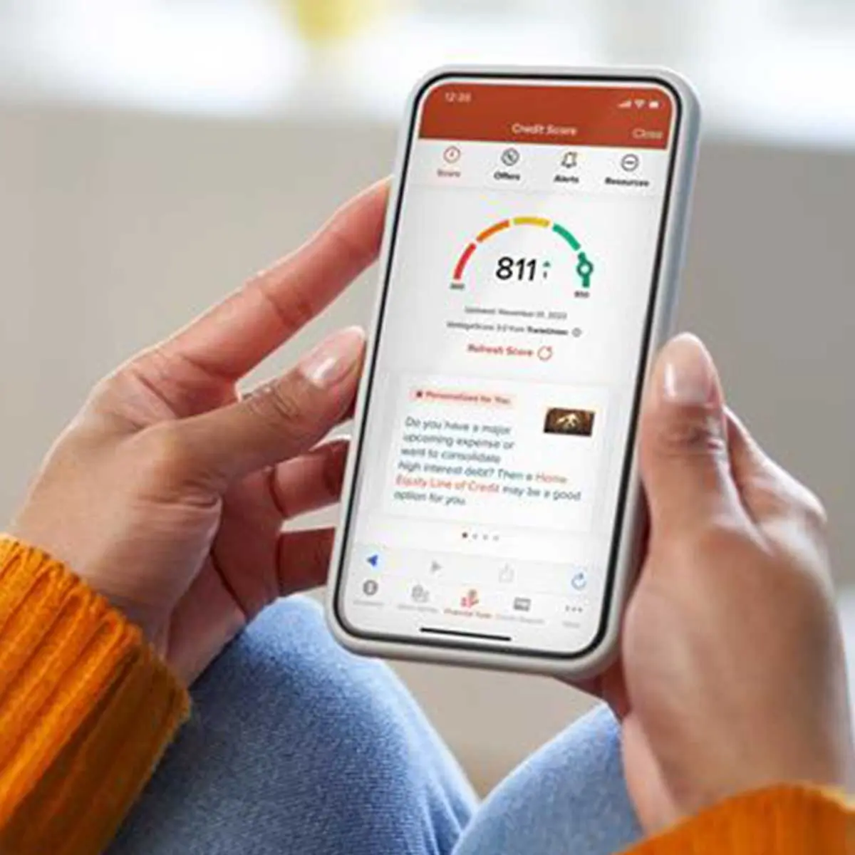 Woman monitoring her credit score with the 1st Source Bank app; a great step towards building good credit