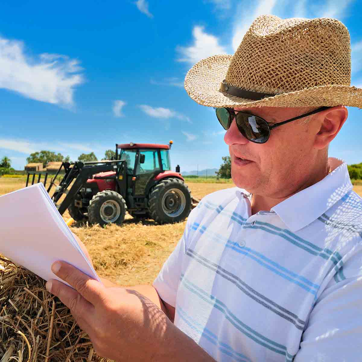 Male farmer looking over financial records for agricultural tax preparation