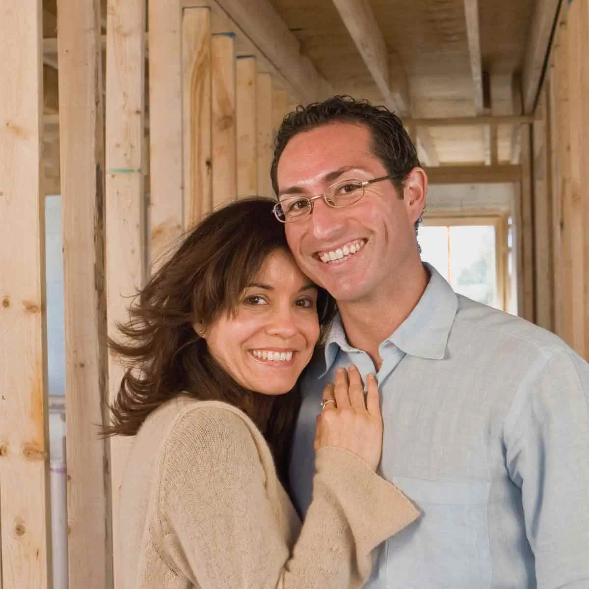 Couple overseeing home renovation project, smiling because they planned their financing in advance with a Home Equity Loan.
