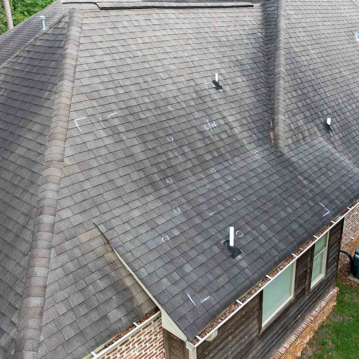 House with visible roof damage, illustrating rising repair costs and insurance coverage changes