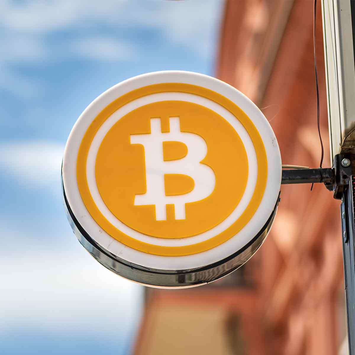 Sign advertising Bitcoin near a cryptocurrency ATM