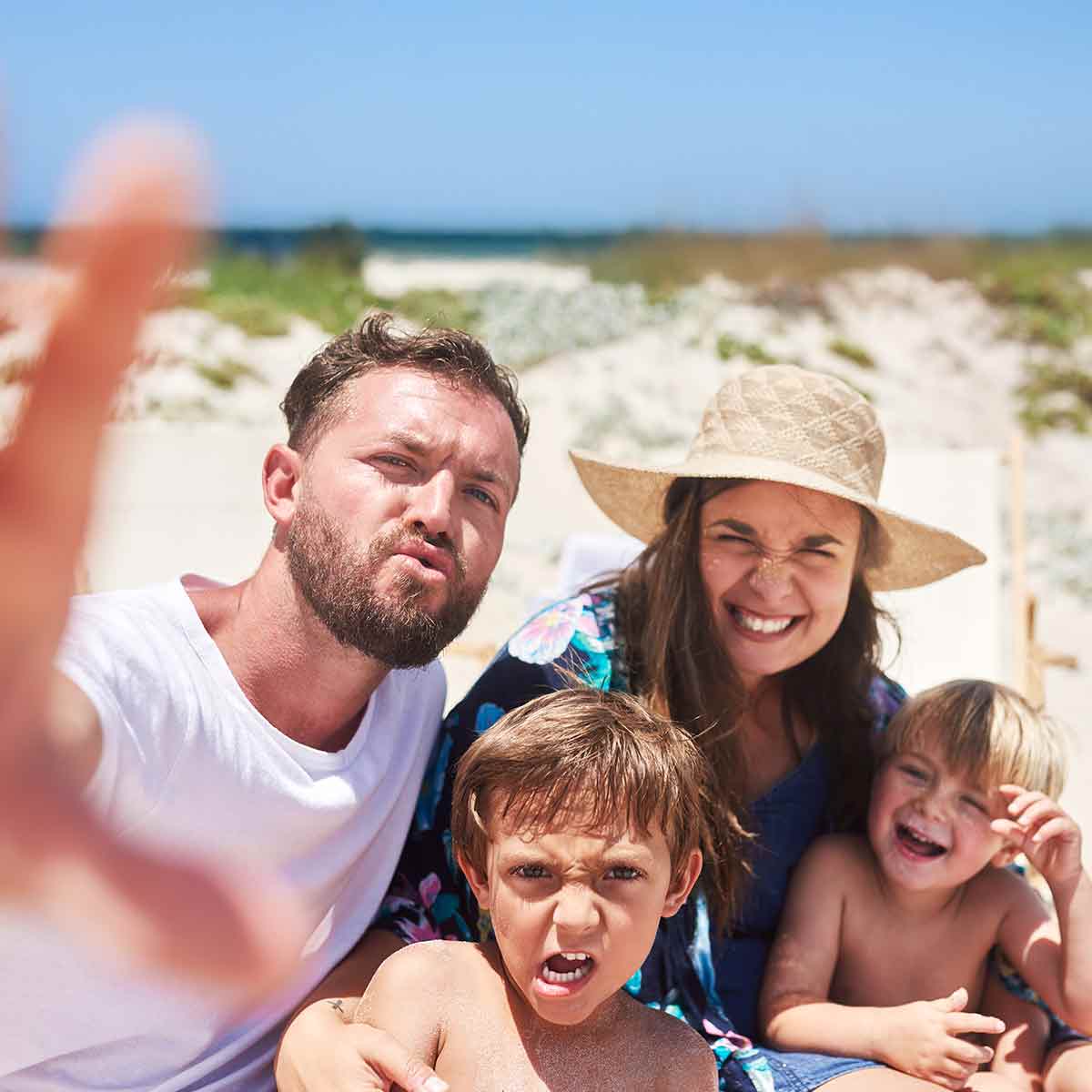 Family taking a selfie on the beach during a summer vacation