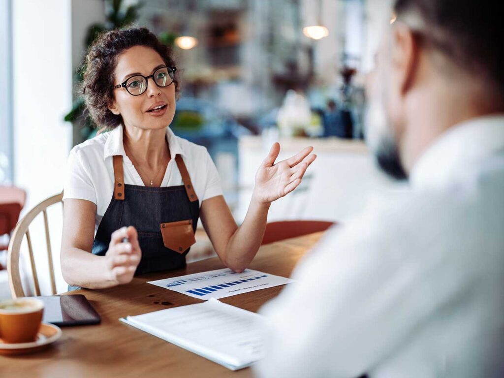 A coffee shop owner and banker discuss business strategy