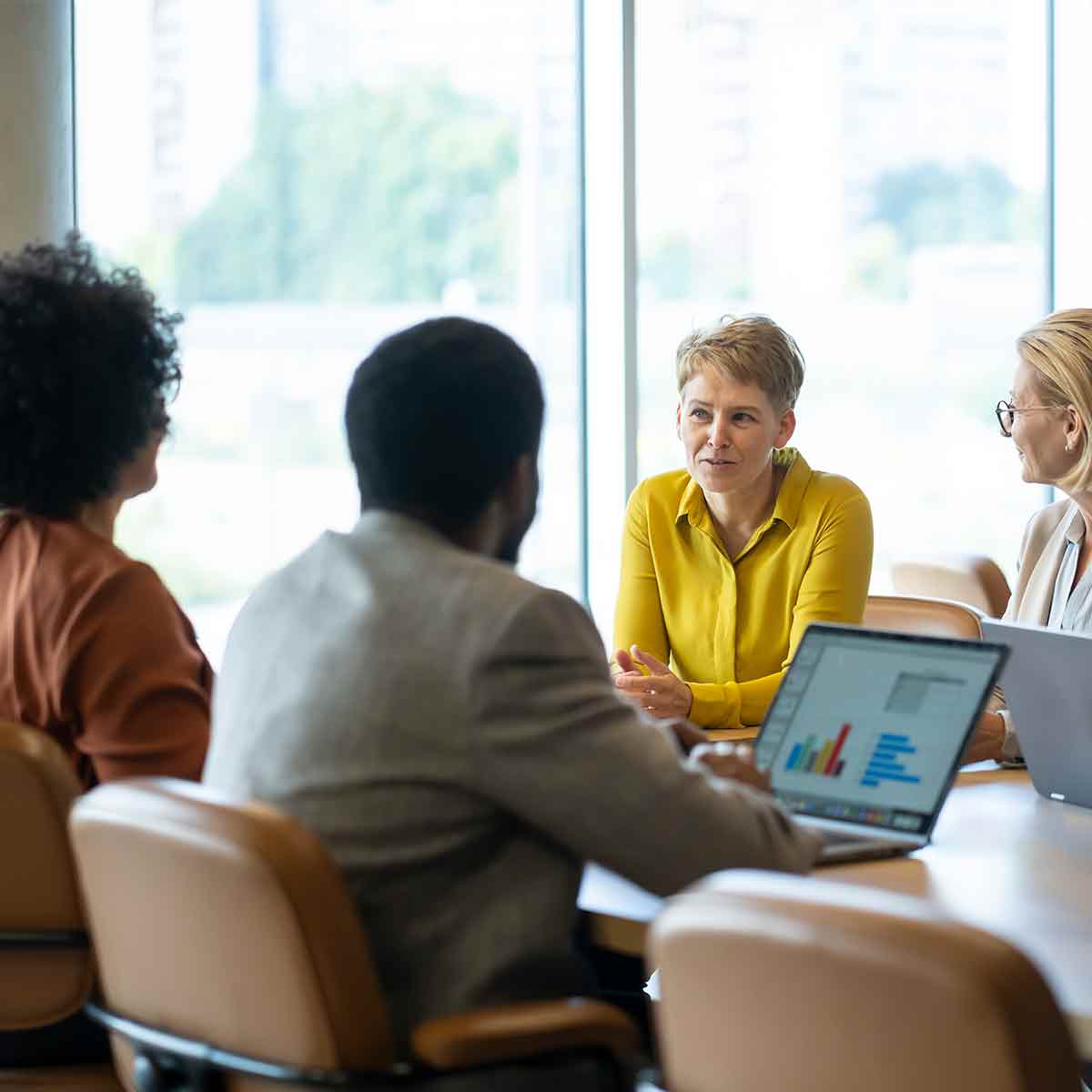 Group of financial advisors meeting around a conference table during a client planning discussion