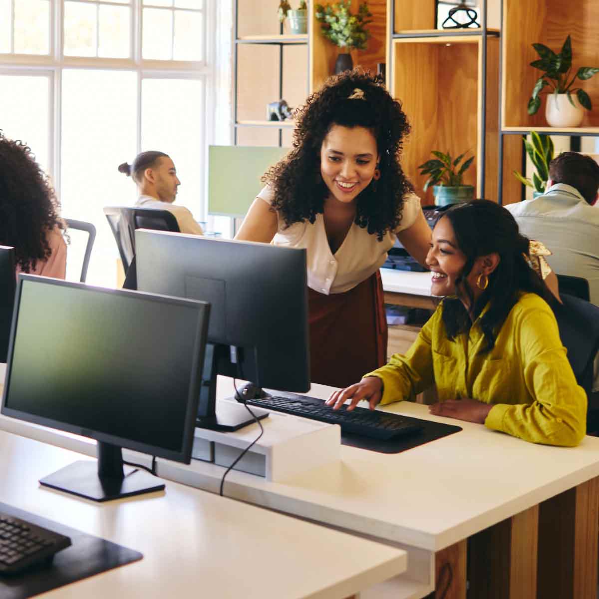 Group of professionals collaborating in an office, highlighting recent employment market trends