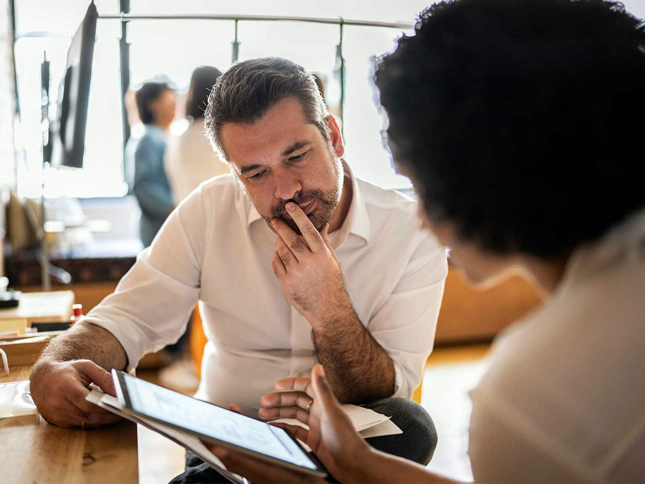 Business owner reviewing retirement plan details with a consultant